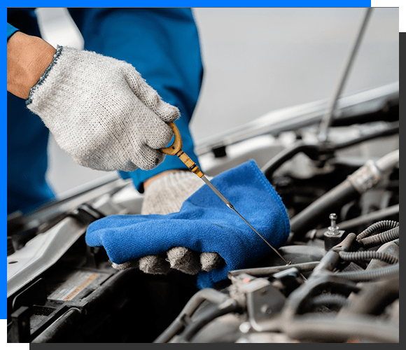 Mechanic checking engine oil